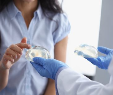 A patient selecting breast implants with guidance from a doctor.