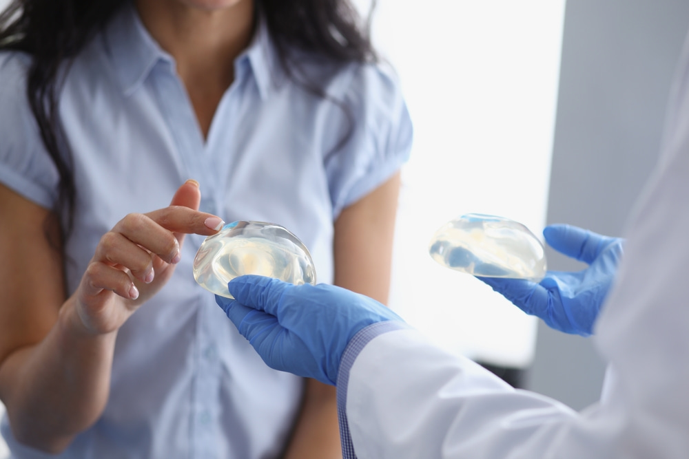 A patient selecting breast implants with guidance from a doctor.